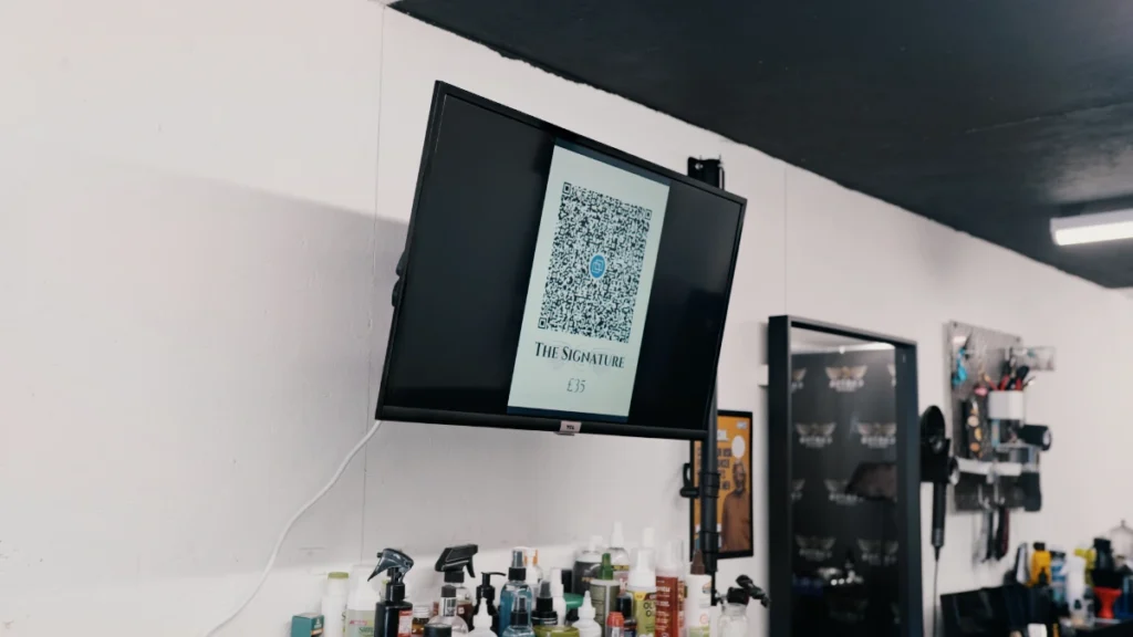 QR code payment shown om screen at Carter Creative barbers in Manchester