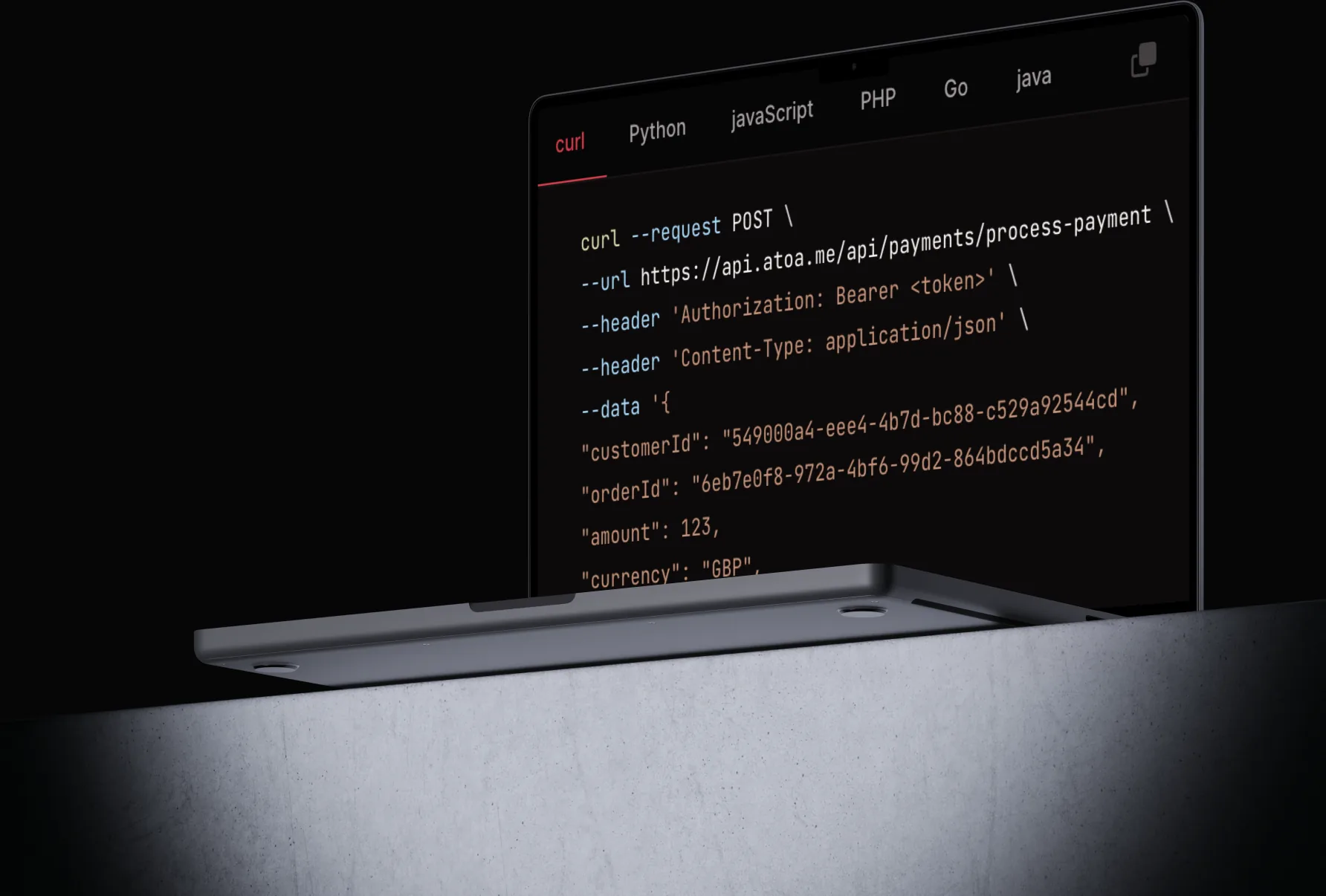 A laptop showing the Atoa payments API in a code editor: a curl POST to api.atoa.me/api/payments/process-payment with tabs for Python, JavaScript, PHP, Go and Java.