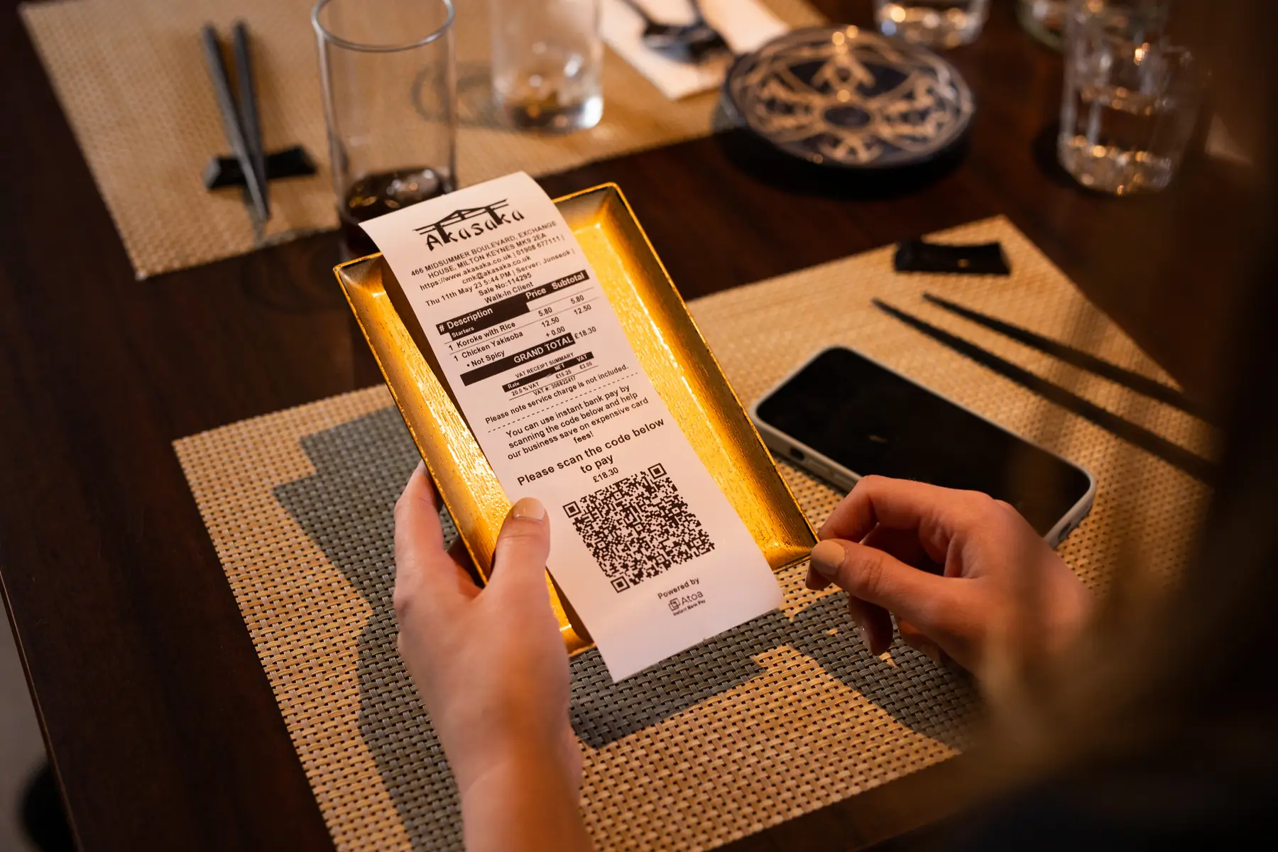 Restaurant guest paying at the table by scanning an Atoa QR code with their phone